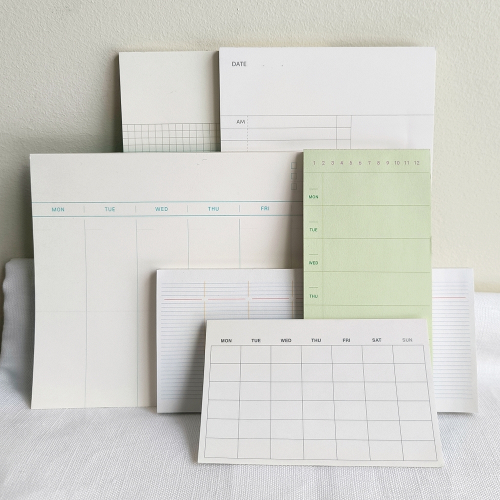 Bundle of Korean stationery planning notepads including daily, weekly, monthly